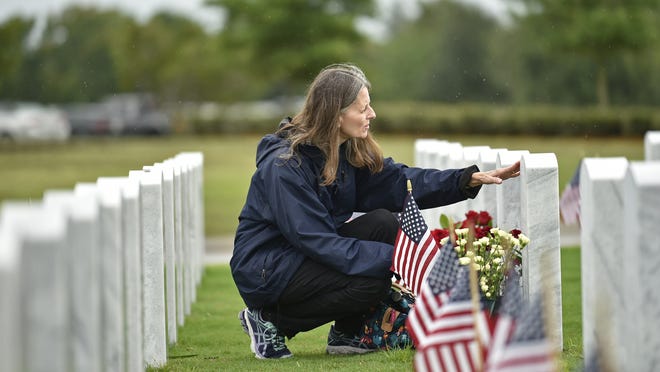 Donna Pletsch of Sarasota at her husband's gravesite last year at the Sarasota National Cemetery. [Thomas Bender/GateHouse Media]