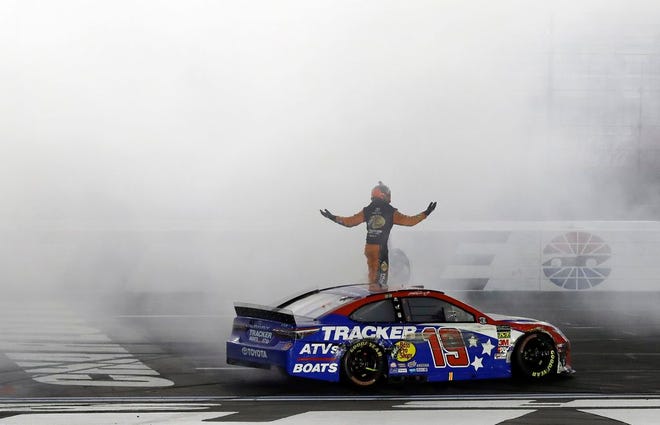 Martin Truex Jr. celebrates after winning the NASCAR Cup Series auto race at Charlotte Motor Speedway in Concord, N.C., Sunday.