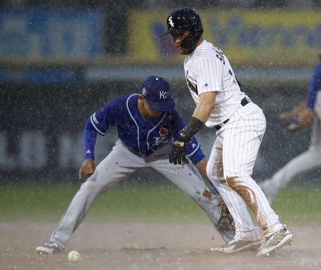 The Chicago White Sox's Yolmer Sanchez, right, is safe at second base as Kansas City Royals' Nicky Lopez drops the ball during the fifth inning in the rain Monday in Chicago. [JIM YOUNG/THE ASSOCIATED PRESS]