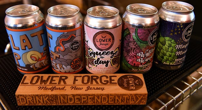 Canned beer brewed at Lower Forge in Medford, is available for customers to purchase, Tuesday, Sept. 26, 2017. [Nancy Rokos / staff photojournalist]
