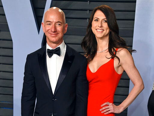 FILE - In this March 4, 2018 file photo, Jeff Bezos and wife MacKenzie Bezos arrive at the Vanity Fair Oscar Party in Beverly Hills, Calif. MacKenzie Bezos is pledging half her fortune to charity, following in the footsteps of billionaires Warren Buffett and Bill Gates. The ex-wife of Amazon founder and CEO Jeff Bezos finalized her divorce in April 2019 and reportedly got a stake in the online shopping giant worth over $35 billion. (Photo by Evan Agostini/Invision/AP, File)