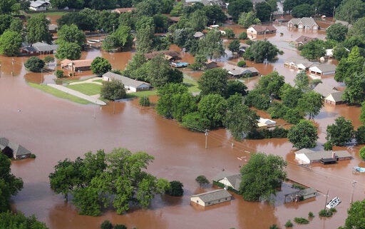 Homes are flooded near the Arkansas River in Tulsa, Okla., on Friday, May 24, 2019. The threat of potentially devastating flooding continued Friday along the Arkansas River from Tulsa into western Arkansas. (Tom Gilbert/Tulsa World via AP)