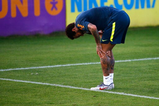 Brazil's soccer player Neymar touches his left knee during a practice session at the Granja Comary training center ahead of the Copa America tournament, in Teresopolis, Brazil, Tuesday, May 28, 2019. (AP Photo/Leo Correa)