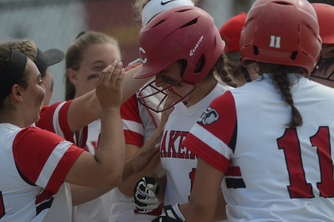 Coventry's Hannah Hawley gets mobbed by teammates after her 3-run home run in the third inning of the Oakers' win over East Providence on Monday. [The Providence Journal / Eric Rueb]