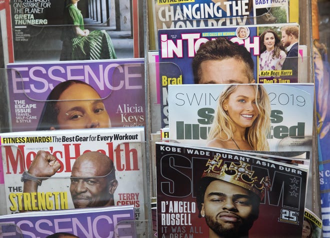 An issue of Sports Illustrated is displayed on a newsstand Tuesday in New York. Authentic Brands Group, which manages retail names like Juicy Couture and Nautica, is buying the sports magazine for $110 million. [MARK LENNIHAN/THE ASSOCIATED PRESS]