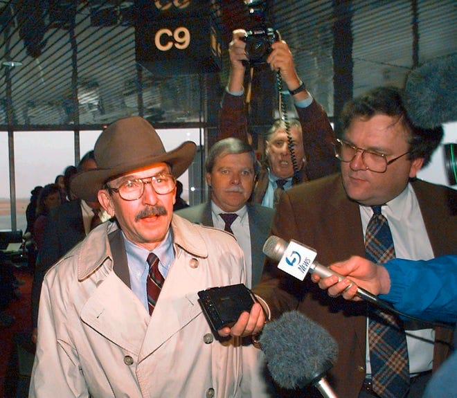 FILE - In this Dec. 12, 1995, file photo, U.S. Federal Judge Richard Matsch is swarmed by reporters and photographers as he arrives at Will Rogers World Airport in Oklahoma City. Matsch, the no-nonsense federal judge who gained national respect overseeing the Oklahoma City bombing trials died on Sunday, May 26, 2019, Jeffrey Colwell, the clerk of Colorado's federal court said. He was 88. (AP Photo/David Longstreath, File)
