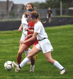Ballard’s Erin Rochleau (center) fights Webster City’s Livia Taylor for possession during the first half of the Bombers’ 10-0 victory over the Lynx in the Class 2A regional quarterfinals of girls’ soccer May 23 at Rich Strouse Field in Huxley.