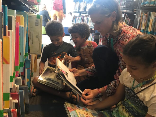 Paige Pozzi and her three children, Ila, Max and Leo, visit the Lake Travis Community Library at least once every two weeks to take advantage of programs and resources. The family also participates in the library's summer reading program. [LUZ MORENO-LOZANO]