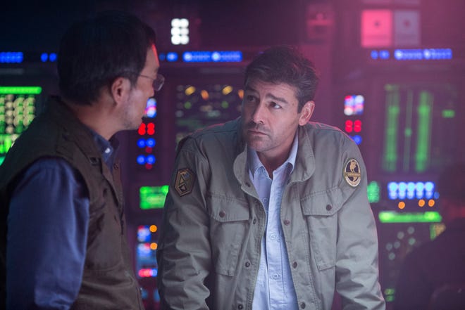 This image shows Ken Watanabe, left, and Kyle Chandler in a scene from "Godzilla: King of the Monsters." [Warner Bros.]