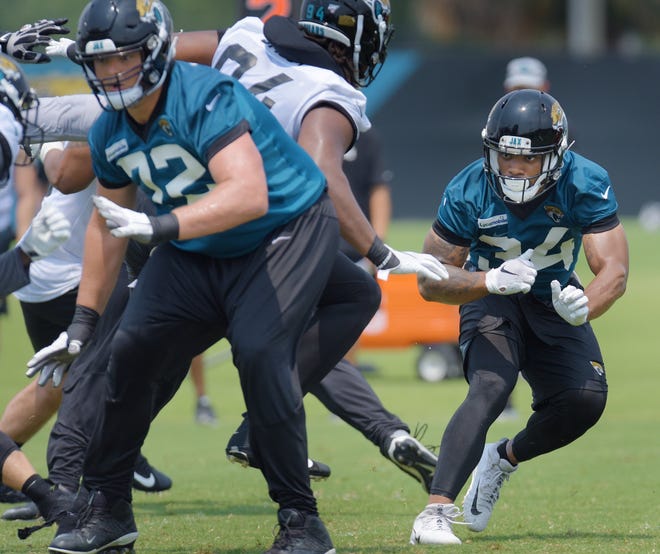 Jaguars running back Thomas Rawls (34) runs through a play during an organized team activities session on Tuesday. Rawls signed with the Jaguars in January and is battling for a roster spot behind starter Leonard Fournette. [Bob Self/Florida Times-Union]
