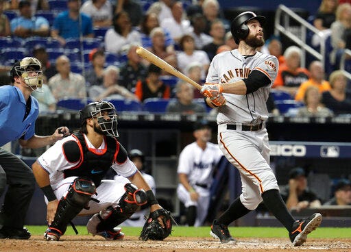 San Francisco Giants' Brandon Belt watches his solo home run, next to Miami Marlins catcher Jorge Alfaro during the fourth inning of a baseball game Wednesday, May 29, 2019, in Miami. (AP Photo/Lynne Sladky)