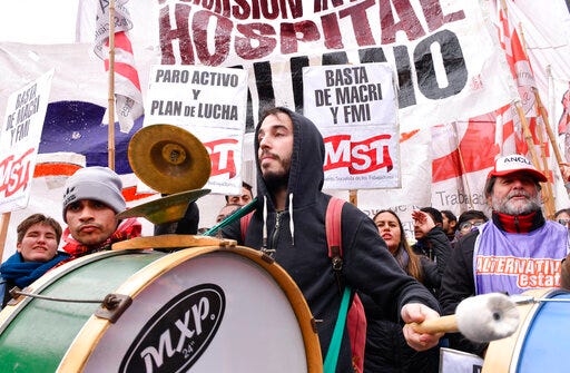 A protester plays a drum during a general strike against austerity measures implemented by President Maurico Macri's government in Buenos Aires, Argentina, Wednesday, May 29, 2019. Dozens of flights were canceled while banks, schools and the public administration closed their doors during the fifth national strike during President Maurico Macri's government. (AP Photo/Gustavo Garello)