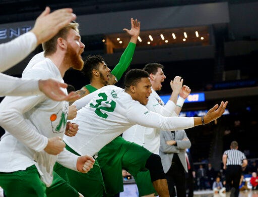FILE - In this Saturday, March 10, 2018, file photo, then-Marshall guard Phil Bledsoe (32) and the Marshall bench react to a 3-point shot against Western Kentucky during the second half of the NCAA Conference USA basketball championship game in Frisco, Texas. Confusion over the new rule allowing college basketball players to sign with agents has led to uncertainty for Bledsoe, now at Division II Glenville State in West Virginia. (AP Photo/Michael Ainsworth, File)