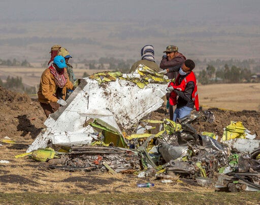 FILE - In this March 11, 2019, file photo, rescuers work at the scene of an Ethiopian Airlines flight crash near Bishoftu, Ethiopia. Pilot Bernd Kai von Hoesslin pleaded with his bosses for more training on the Boeing Max, just weeks before the Ethiopian Airline’s jet crashed, killing everyone on board. (AP Photo/Mulugeta Ayene, File)