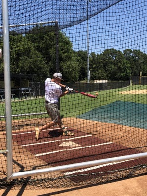 Mosley's Blake Vineyard hits a pitch during batting practice Wednesday at Buchholz High School. [PHOTO BY ELLEN GRAINGER]