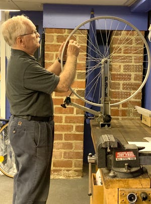 Bikesmith owner Allen Snyder works on a wheel in his new shop, just below his old location. The shop is located at 48 South Street, and opened this week.