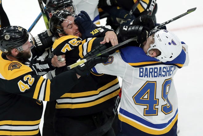 Boston Bruins' Connor Clifton (75) tangles with St. Louis Blues' Ivan Barbashev (49), of Russia, during the first period in Game 2 of the NHL hockey Stanley Cup Final, Wednesday, May 29, 2019, in Boston. (AP Photo/Charles Krupa)