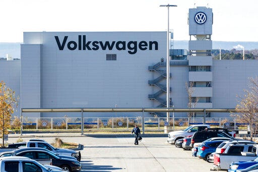 FILE - In this Dec. 4, 2015, file photo, a man walks through the employee parking lot at the Volkswagen plant in Chattanooga, Tenn. Tennessee Republican Gov. Bill Lee says he opposes a push by the United Auto Workers union to organize Volkswagen's lone U.S. plant in the state. The Times Free Press quoted Lee as saying Thursday, May 30, 2019, that business recruitment will take a hit if employees at the Chattanooga plant decide they want union representation. (AP Photo/Erik Schelzig, File)