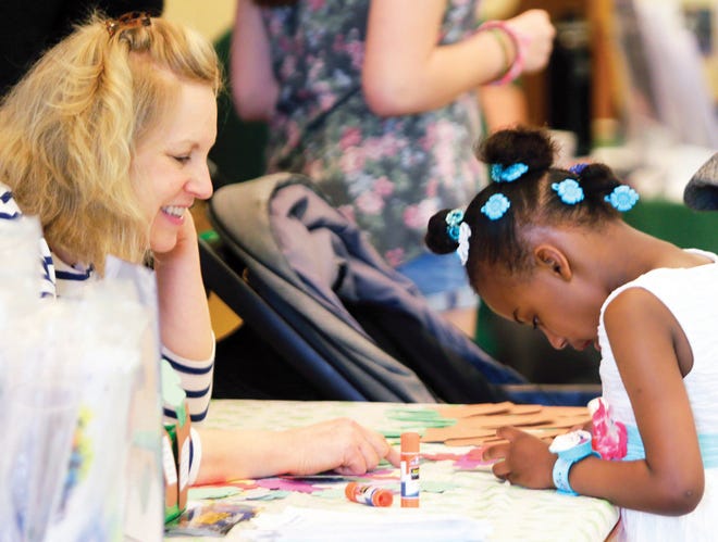 Photo by Jake West / New Jersey Herald
 Ziva Patrick does arts and crafts with Jenise Sileo, from the Sussex County Library, during the Family Expo held recently at Project Self Sufficiency in Newton.