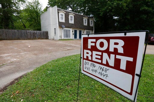FILE - In this April 23, 2018, file photo a for rent sign denotes the availability of another existing home in Jackson, Miss. Buying a home is often seen as a no-brainer if you have the means. But continuing to rent can give you more flexibility, amenities and time. It can also give you a sense of financial security, since there’s no down payment, repairs or closing costs to eat through your nest egg. (AP Photo/Rogelio V. Solis, File)