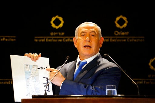 CORRECTS PHOTOGRAPHER TO ARIEL SCHALIT FROM SEBASTIAN SCHEINER - Israeli Prime Minister Benjamin Netanyahu shows a map from US President Donald Trump during statements to the press in Jerusalem, Thursday, May 30, 2019. President Donald Trump's son-in-law and senior adviser Jared Kushner met with Israeli Prime Minister Benjamin Netanyahu on Thursday to push the Trump administration's long-awaited plan for Mideast peace, just as Israel was thrust into the political tumult of an unprecedented second election in the same year. (AP Photo/Ariel Schalit)