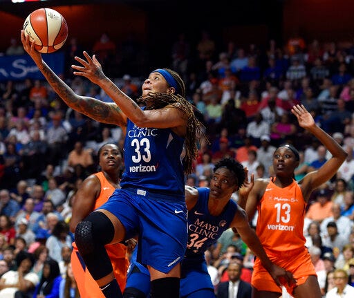 FILE - In this June 9, 2018, file photo, Minnesota Lynx guard Seimone Augustus (33) uses a screen from teammate Sylvia Fowles (34) to get a clear drive to the basket against the Connecticut Sun during the first half of a WNBA basketball game in Uncasville, Conn. Minnesota Lynx guard Seimone Augustus will be out indefinitely following arthroscopic knee surgery. The Lynx announced Augustus had the procedure Thursday, May 30, 2019, at the Mayo Clinic in Rochester, Minnesota. The 35-year-old Augustus is the franchise leader in games played, points scored and field goals made after being selected with the first pick in the 2006 draft.(Sean D. Elliot/The Day via AP, File)