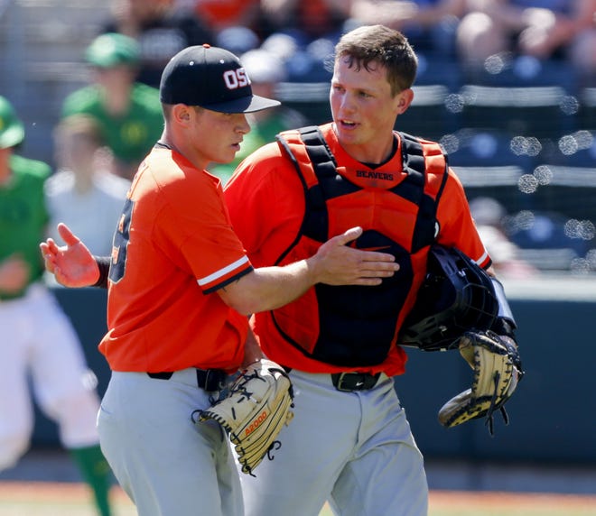 Pitcher Dylan Pearce (left), catcher Adley Rutschman and the Oregon State baseball team open the NCAA Tournament on Friday at home against Cincinnati. [Andy Nelson/The Register-Guard] - registerguard.com