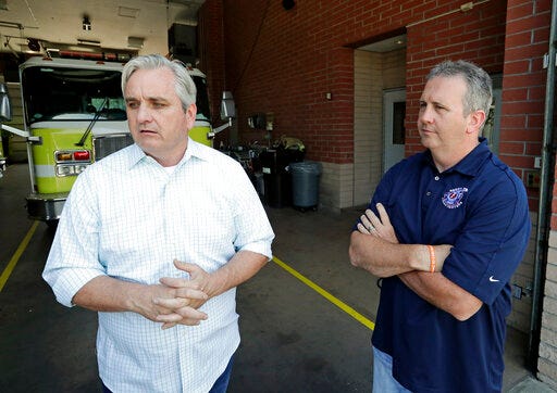 In this Tuesday, May 28, 2019 photo, Timothy Stromsnes, left, president of the Reedy Creek Professional Firefighters, Local 2117 and union vice president Sean Pierce air concerns about the firefighting staff at Walt Disney World in Lake Buena Vista, Fla. Firefighters for Walt Disney World's private government say they're vastly understaffed, posing a safety risk as the 25,000-acre Florida theme park resort grows even bigger this year with the debuts of a new Star Wars land, a new air-gondola system and even more hotel rooms. (AP Photo/John Raoux)