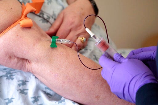 FILE - In this Tuesday, April 28, 2015 file photo, a patient has her blood drawn at a hospital in Philadelphia to monitor her cancer treatment. Companies are trying to develop blood tests that can look for signs of many types of cancer at once. (AP Photo/Jacqueline Larma, File)