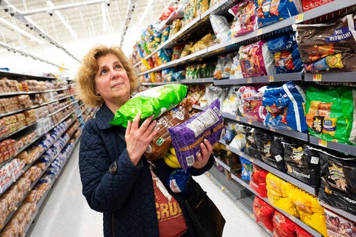 FILE - In this April 24, 2019, file photo Marcy Seinberg shops at a Walmart Neighborhood Market in Levittown, N.Y. On Friday, May 31, the Commerce Department issues its April report on consumer spending, which accounts for roughly 70 percent of U.S. economic activity. (AP Photo/Mark Lennihan, File)