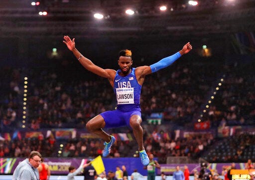 FILE - In this March 2, 2018, file photo, United States' Jarrion Lawson makes an attempt in the men's long jump final at the World Athletics Indoor Championships in Birmingham, Britain. Paul Doyle, the agent for Jarrion Lawson told The Associated Press on Friday, May 31, 2019, that the American long jumper and sprinter is expected to receive a four-year suspension for a failed doping test they maintain is tied to contaminated meat. (AP Photo/Matt Dunham, File)