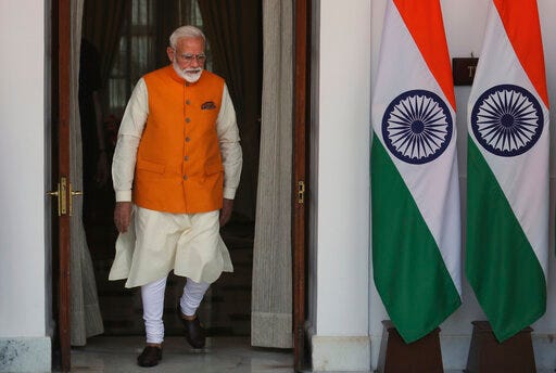 Indian Prime Minister Narendra Modi leaves to receive one of the leaders from a neighboring country for a bilateral meeting in New Delhi, India, Friday, May 31, 2019. India's newly sworn in Prime Minister Narendra Modi named a Cabinet on Friday, handing the powerful home affairs portfolio to the president of his Hindu nationalist party credited with delivering him a thunderous reelection and appointing a former diplomat to signal the government's focus on foreign policy. (AP Photo/Manish Swarup)