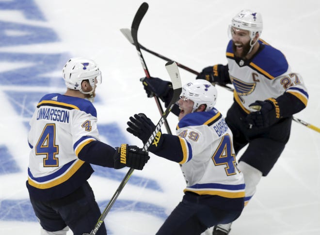 St. Louis’ Carl Gunnarsson is congratulated by teammates Ivan Barbashev and Alex Pietrangelo after he scored the winning goal in overtime Wednesday at TD Garden. [Charles Krupa/The Associated Press]