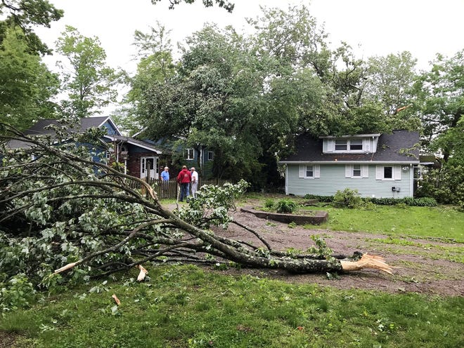 A tree limb fell near a home in Stanhope, N.J., Wednesday, May 29, 2019. The National Weather Service confirmed that a tornado struck Tuesday night in an area not accustomed to them. [KAITLYN KANZLER/THE RECORD via AP]
