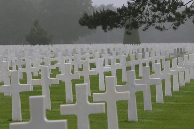 FILE - In this June 6, 2018, file photo, headstones at the Colleville American military cemetery, in Colleville sur Mer, western France. The world will turn its eyes to the beaches of France to mark the 75th anniversary of the D-Day. The United States’ representative at the solemn ceremony in Normandy will be President Donald Trump, whose complicated relationship with the armed forces includes allegations of draft dodging, feuds with Gold Star families and considerations of pardoning soldiers accused of war crimes. (AP Photo/David Vincent, File)