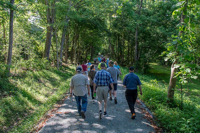 People take advantage of the Deep River Rail Trail after the newest portion in downtown Franklinville was officially unveiled Saturday morning. (Paul Church / The Courier Tribune)
