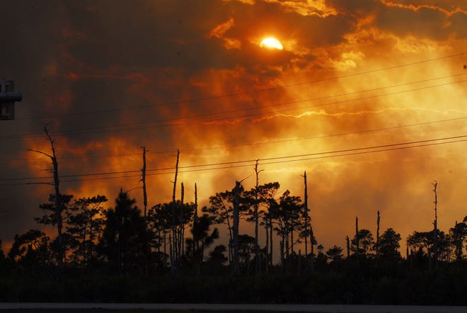 Flames from a brush fire lit up the sky west of Interstate 95 in Volusia County in this 2011 file photo. [AP file]
