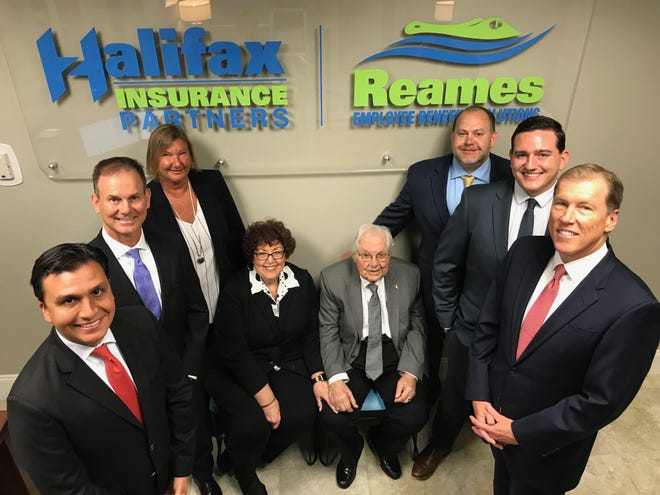 Foundation Risk Partners CEO Charlie Lydecker, far right front, is pictured with several of his company's senior management team. Also pictured, from left: Alan Florez, Andy Thomas, Lisa Farrash, Julie and Bert Reames, Rich Cooper and Alex Doberstein. [News-Journal/Clayton Park]