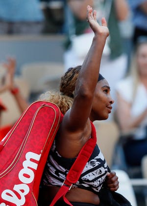 Serena Williams of the U.S. waves goodbye after losing her third round match of the French Open tennis tournament against Sofia Kenin of the U.S. in two sets, 2-6, 5-7, at the Roland Garros stadium in Paris, Saturday, June 1, 2019. (AP Photo/Christophe Ena )