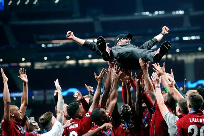 Liverpool coach Juergen Klopp is tossed in the air by teammates as they celebrate after defeating Tottenham Hotspur 2-0 in the Champions League final soccer match at the Wanda Metropolitano Stadium in Madrid, Saturday, June 1, 2019. (AP Photo/Francisco Seco)