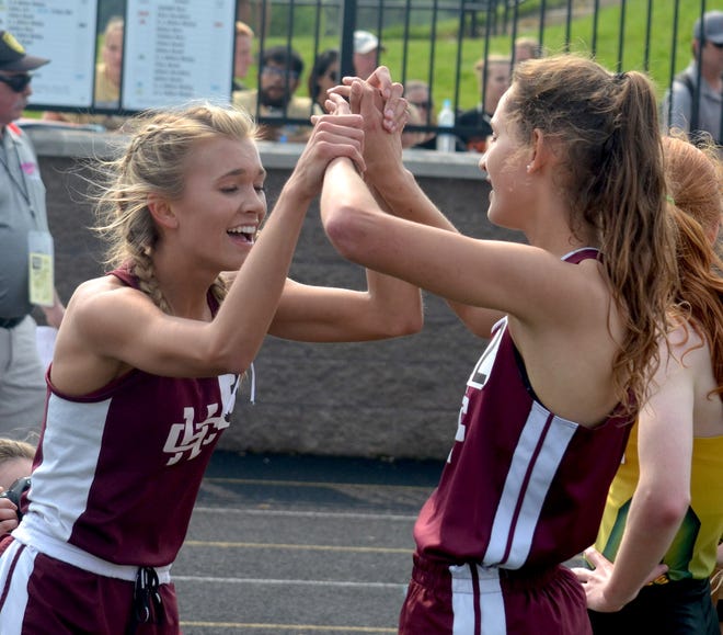 Holland Christian's Gillian Fiene (left) and Michelle Kuipers celebrate a 1-2 finish in the 1,600 at the Division 2 state meet Saturday at Zeeland Stadium. [Dan D'Addona/Sentinel staff]