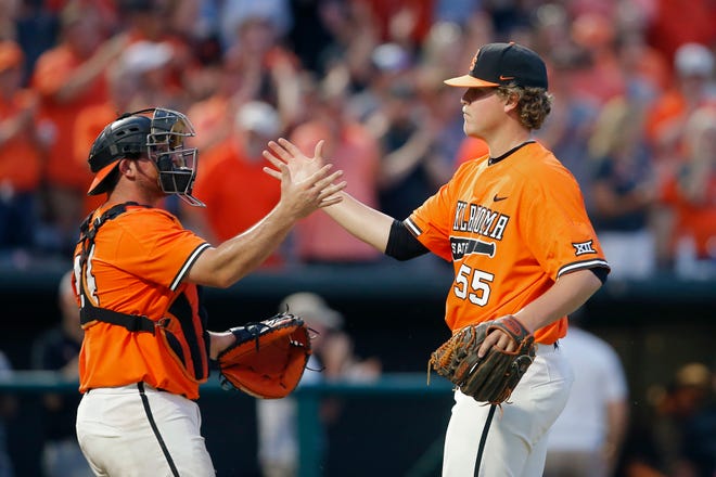 Oklahoma State's Peyton Battenfield (55) and Colin Simpson (24) celebrate after OSU's win in the Oklahoma City Regional NCAA baseball game between Oklahoma State University (OSU) and Harvard at Chickasaw Bricktown Ballpark in Oklahoma City, Friday, May 31, 2019. [Bryan Terry/The Oklahoman]