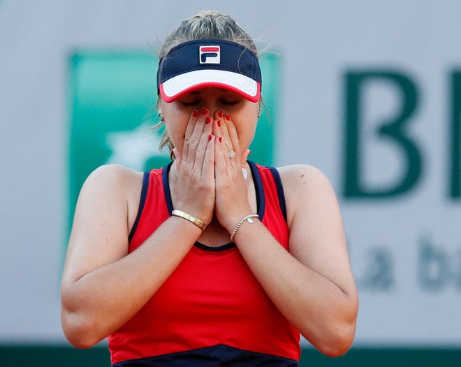 Sofia Kenin celebrates winning her third round match of the French Open against Serena Williams in two sets 6-2, 7-5, at the Roland Garros stadium Saturday in Paris. [Christophe Ena/The Associated Press]