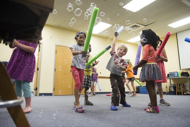 Young Jedi fight back the bubble menace at Pooler Library's Summer Reading Program Kickoff Party on Saturday. This year's theme is space, and the library was filled with Star Wars themed activities. [Will Peebles/Savannahnow.com]