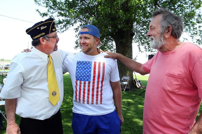 Tony Manley, right, puts his hand on the shoulder of his son, Ryan Manley, center, as the two speak with Jeff Brashaw during a sendoff picnic held for soldiers of the Army National Guard Unit 333 on Sunday, June 2, 2019, in Lanark. [JANE LETHLEAN/THE JOURNAL-STANDARD CORRESPONDENT]