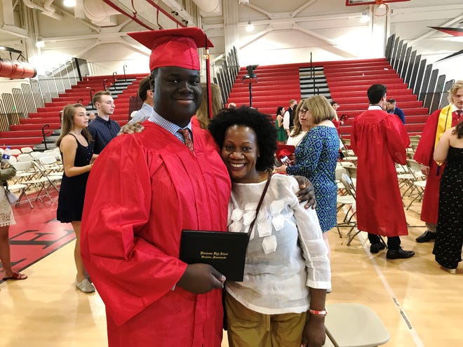 Kelvin Lubega, left, and his mother, Millie Negulu, attend graduation ceremonies at Winchester High School on Sunday, June 2. [Wicked Local Staff Photo/Matt Mallio]