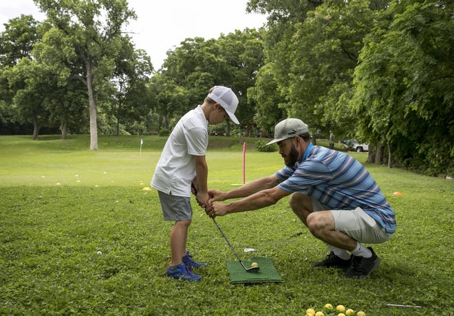 Cody Price, a coach with Golf In Schools, instructs 7-year-old Bennett Underwood on Monday at Butler Park Pitch & Putt. Lee Kinser, the longtime operator of the quirky nine-hole course near Lamar Boulevard and Barton Springs Road, could lose her contract to run the course because she failed to properly submit her bid. [JAY JANNER/AMERICAN-STATESMAN]