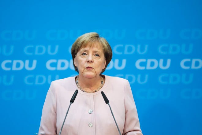 German Chancellor Angela Merkel speaks to media prior to a special closed meeting of her Christian Democratic Union at the party's headquarters in Berlin, Germany, Sunday, June 2.