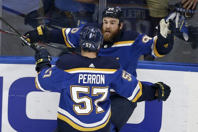 St. Louis Blues center Ryan O'Reilly (90) celebrates with David Perron (57) after O'Reilly scored his second goal of the game during the third period of Game 4 of the NHL hockey Stanley Cup Final against the Boston Bruins on Monday in St. Louis. [Scott Kane/The Associated Press]