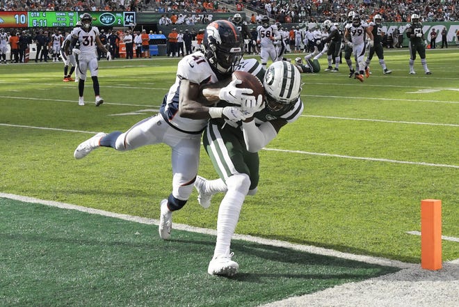 New York Jets receiver Terrelle Pryor (16) catches a touchdown in front of Denver Broncos cornerback Isaac Yiadom on Oct. 7 in East Rutherford, N.J. [AP Photo/Bill Kostroun]